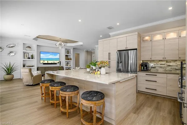 a large kitchen with a table and chairs