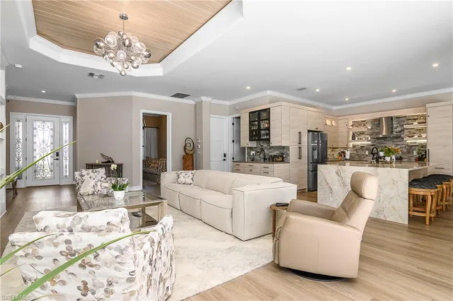 a living room with furniture and a chandelier