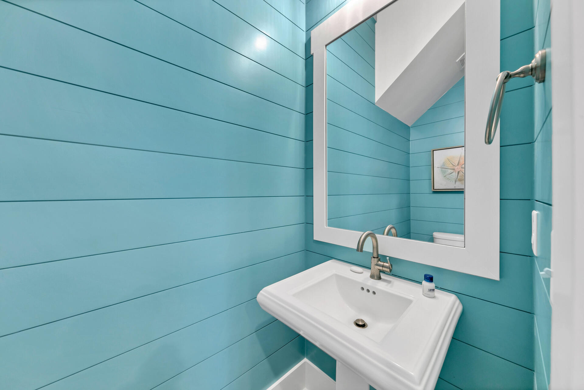 13662 Front Beach Road Panama City Beach, FL 32413 - Photo 14 of 46 a bathroom with a sink and mirror