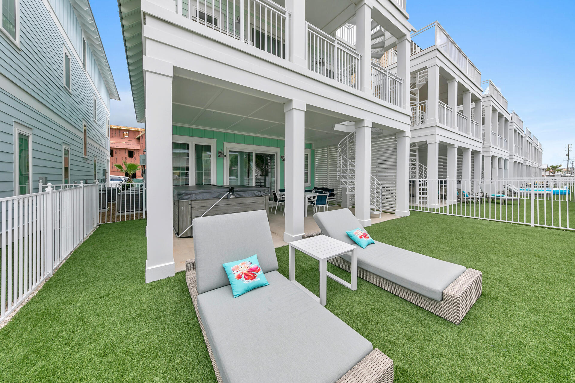 13662 Front Beach Road Panama City Beach, FL 32413 - Photo 16 of 46 a front view of a house with a yard table and chairs