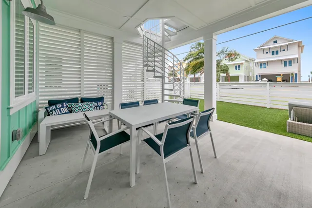 a view of a patio with table and chairs and potted plants