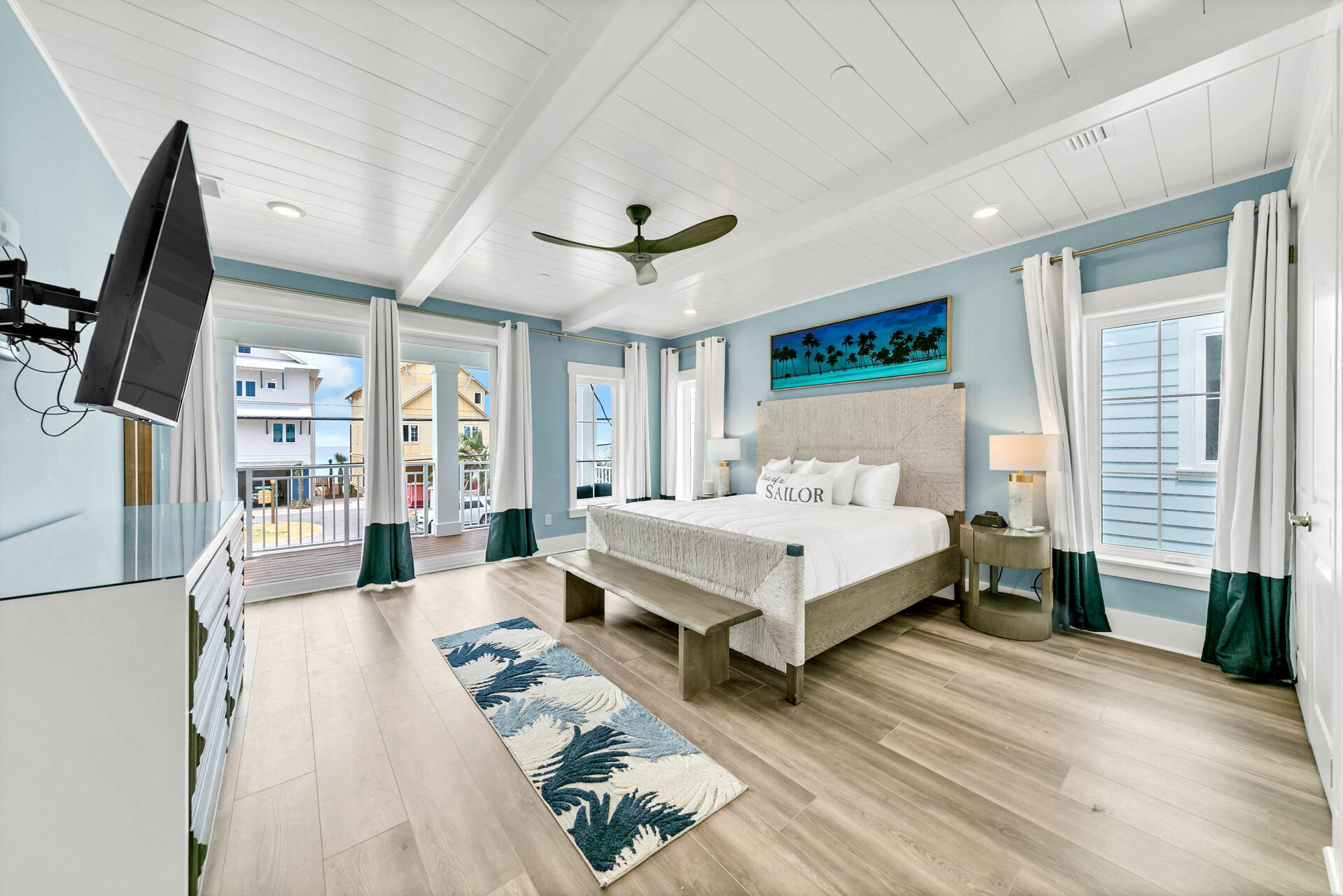 13662 Front Beach Road Panama City Beach, FL 32413 - Photo 19 of 46 a spacious bedroom with a bed a flat screen tv and a large window