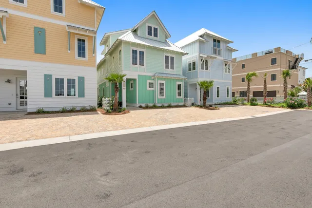 a front view of residential houses with yard