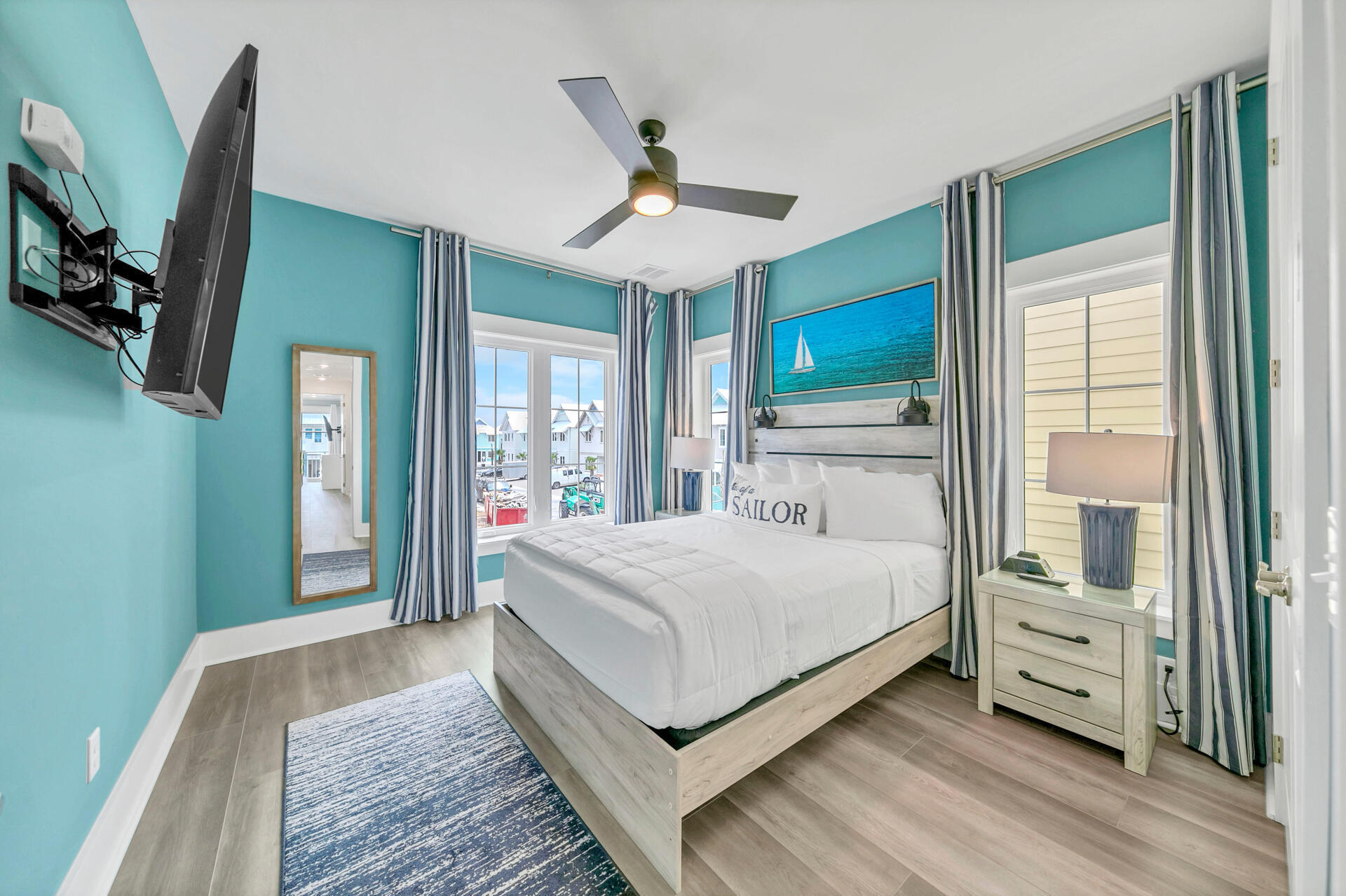 13662 Front Beach Road Panama City Beach, FL 32413 - Photo 26 of 46 a bedroom with a large bed a flat tv screen and dresser