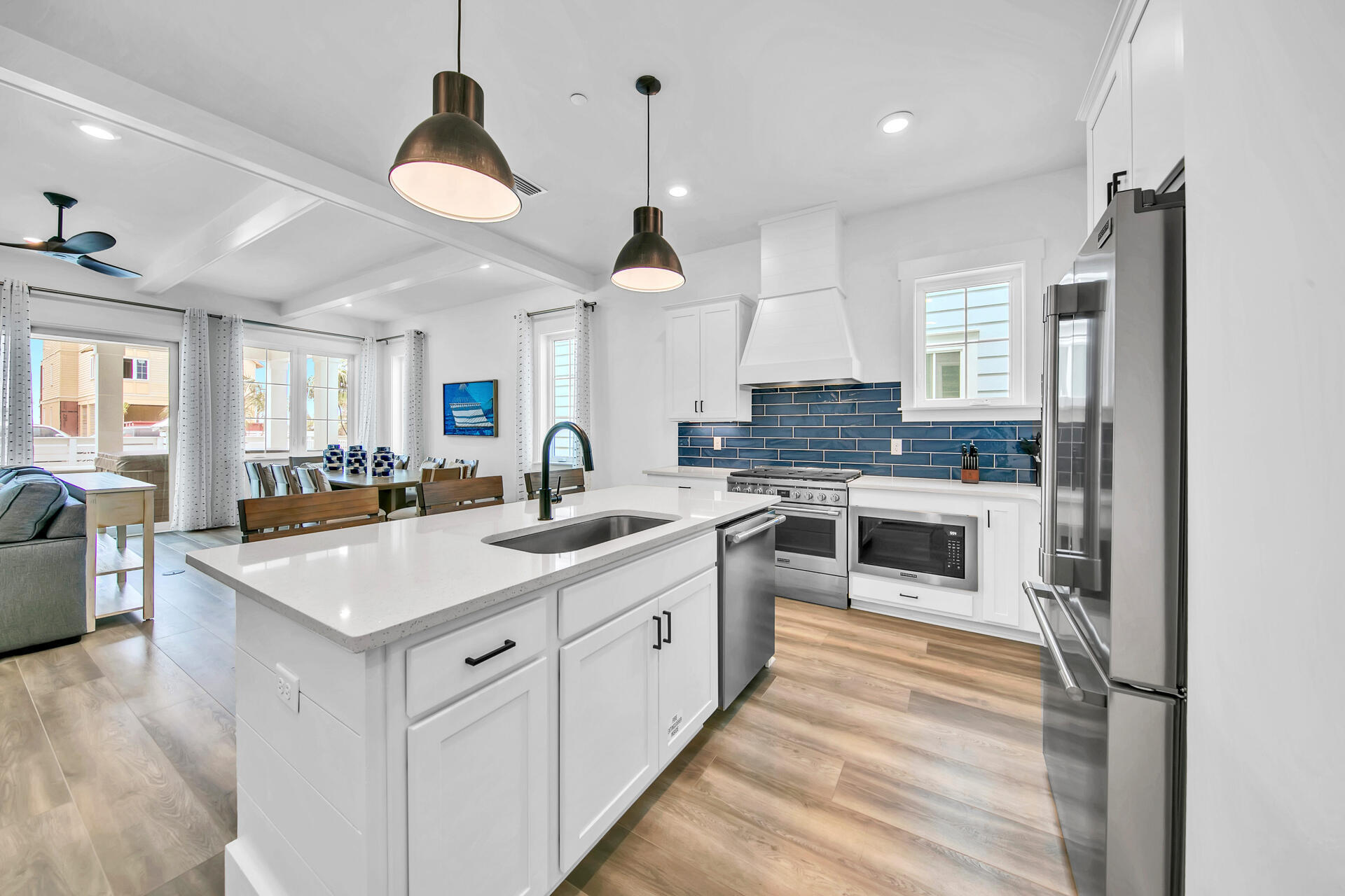 13662 Front Beach Road Panama City Beach, FL 32413 - Photo 3 of 46 a large kitchen with stainless steel appliances kitchen island granite countertop a lot of counter space and a chandelier