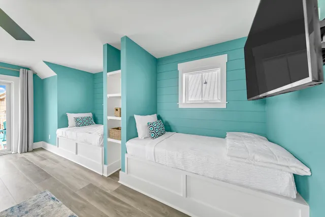 a bedroom with a large bed and a flat screen tv