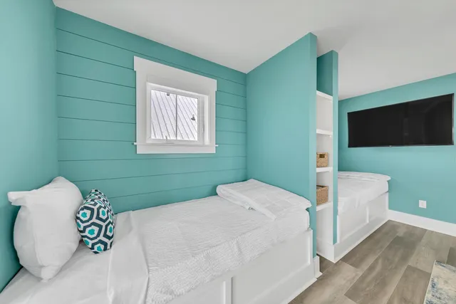 a bedroom with a bed and a flat screen tv