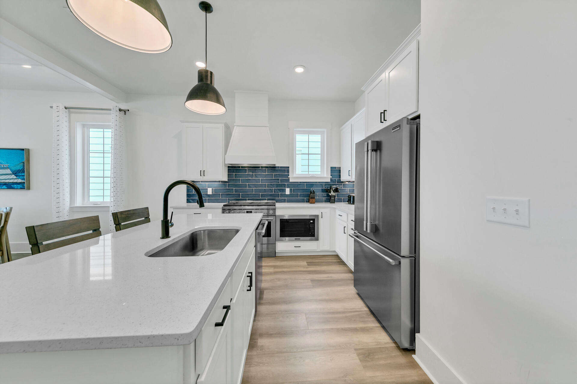 13662 Front Beach Road Panama City Beach, FL 32413 - Photo 8 of 46 a kitchen with stainless steel appliances granite countertop a sink a stove a refrigerator and island