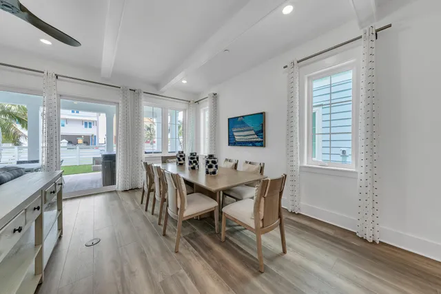 a dining room with furniture and wooden floor