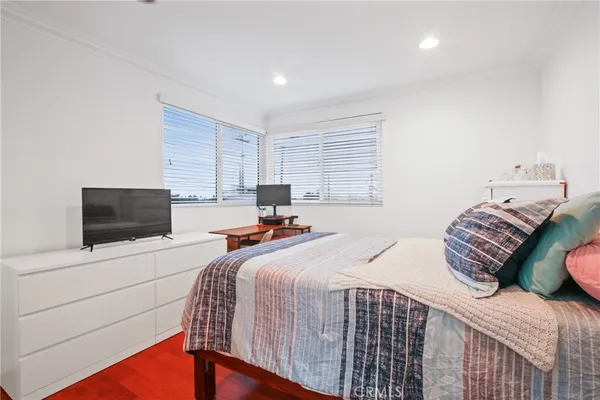 a bedroom with two beds and a television