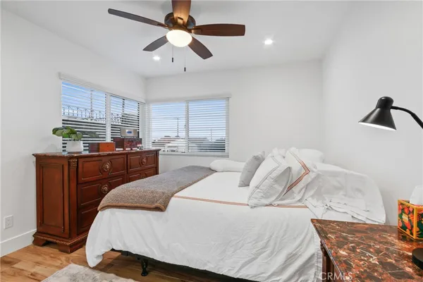 a bedroom with a bed and wooden floor