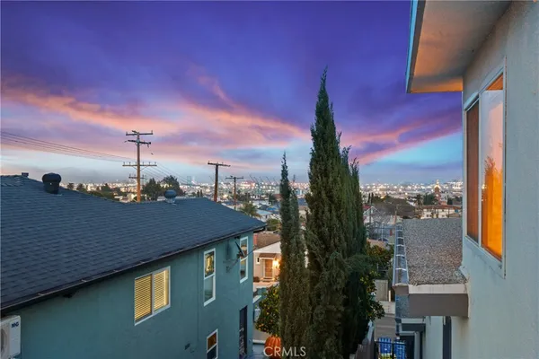 a view of a brick house with large windows