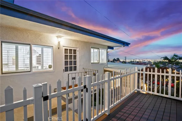 an aerial view of residential houses with outdoor space and parking