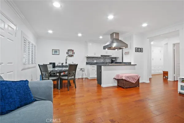 a living room with kitchen island furniture and a wooden floor