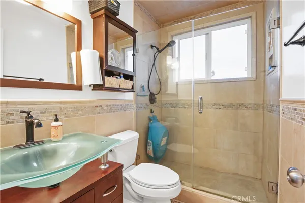 a bathroom with a sink toilet and shower