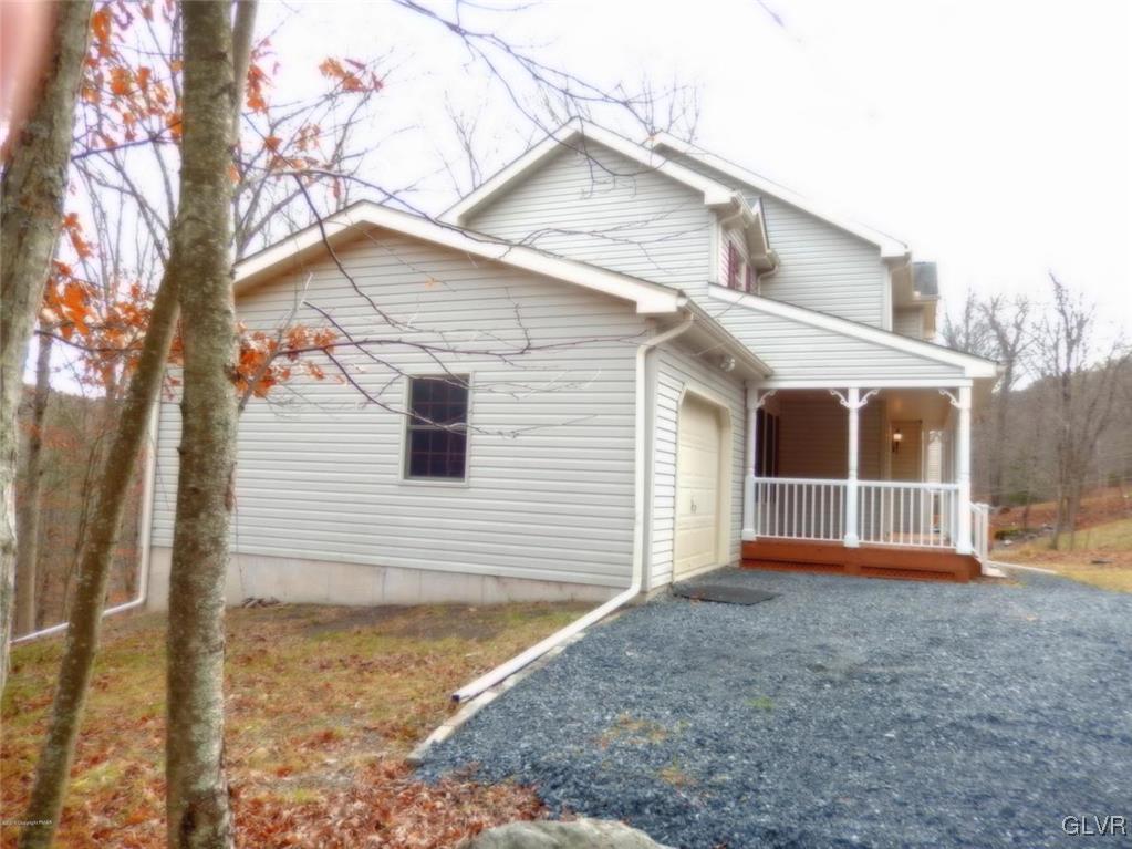 5886 Decker Road Bushkill, PA 18324 - Photo 3 of 15 a view of a house with a yard and wooden fence
