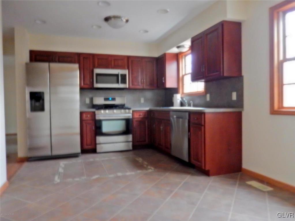 5886 Decker Road Bushkill, PA 18324 - Photo 6 of 15 a kitchen with stainless steel appliances granite countertop a refrigerator and a stove top oven