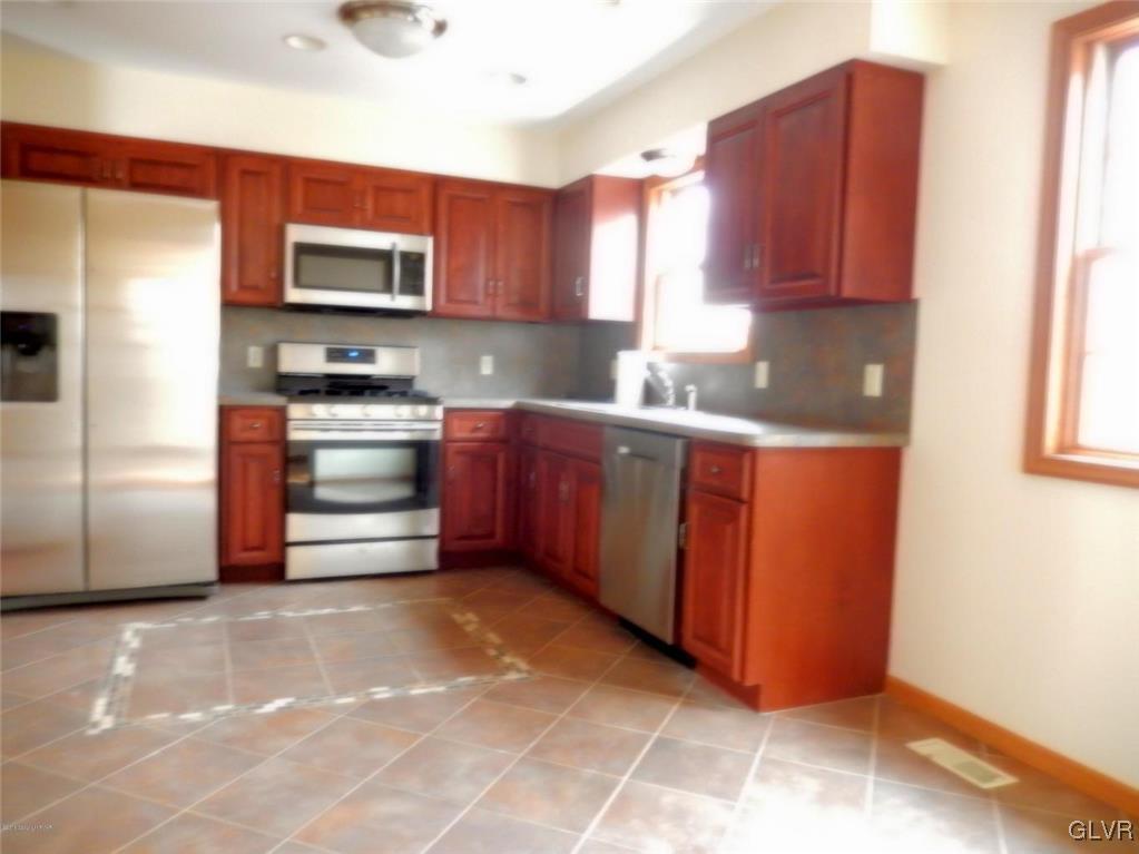 5886 Decker Road Bushkill, PA 18324 - Photo 7 of 15 a kitchen with stainless steel appliances granite countertop a refrigerator and a stove top oven
