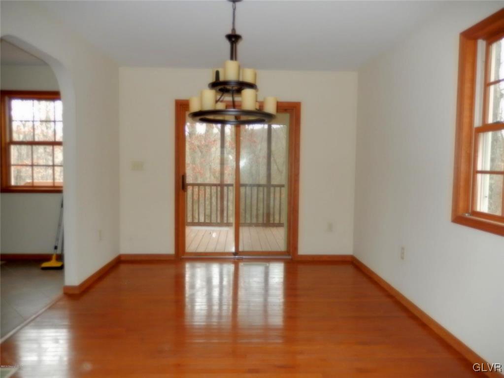 5886 Decker Road Bushkill, PA 18324 - Photo 8 of 15 a view of an empty room with wooden floor and a window