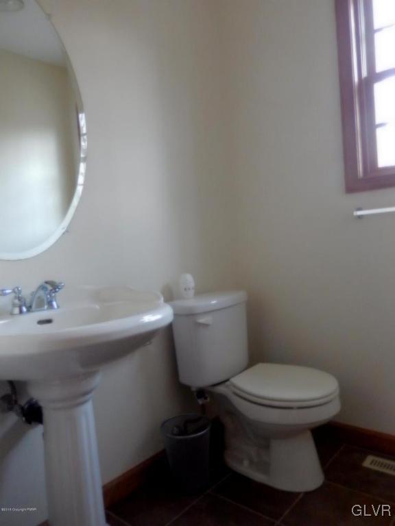 5886 Decker Road Bushkill, PA 18324 - Photo 9 of 15 a white toilet sitting next to a bathroom sink