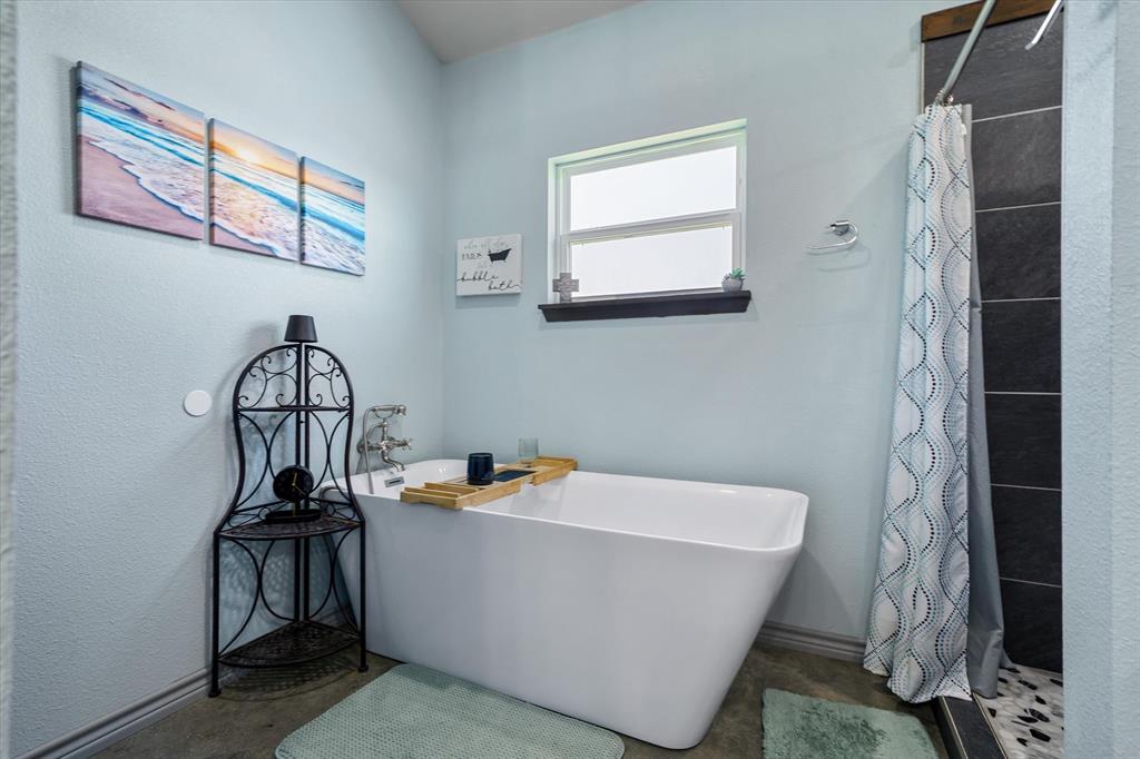 1026 VZ County Road Canton, TX 75103 - Photo 12 of 40 a bathroom with a bathtub and a shower