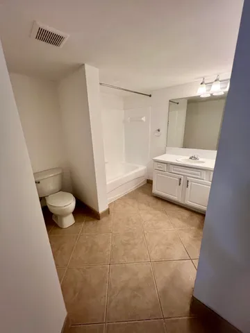 a bathroom with a bathtub and a toilet