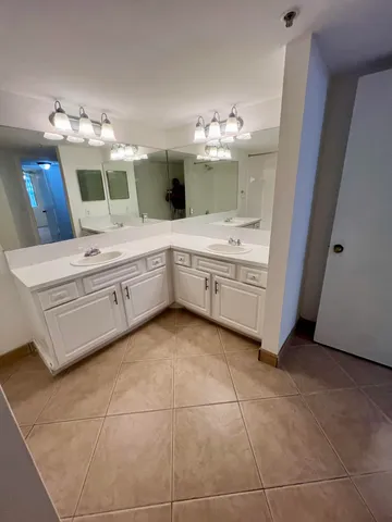 a bathroom with a double vanity sink and a mirror