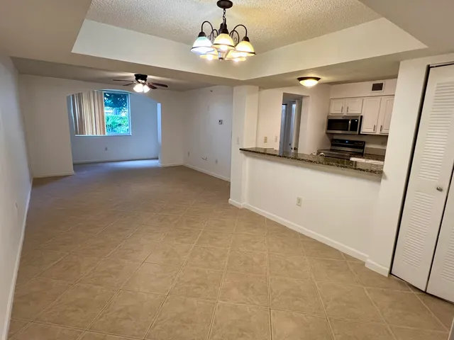 a view of a kitchen with microwave and cabinets