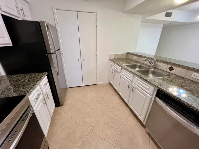 a kitchen with a sink stove and refrigerator