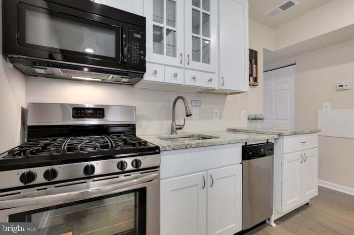 1720 H Street Northeast, Unit A Washington, DC 20002 - Photo 22 of 31 Modern kitchen with sleek finishes.