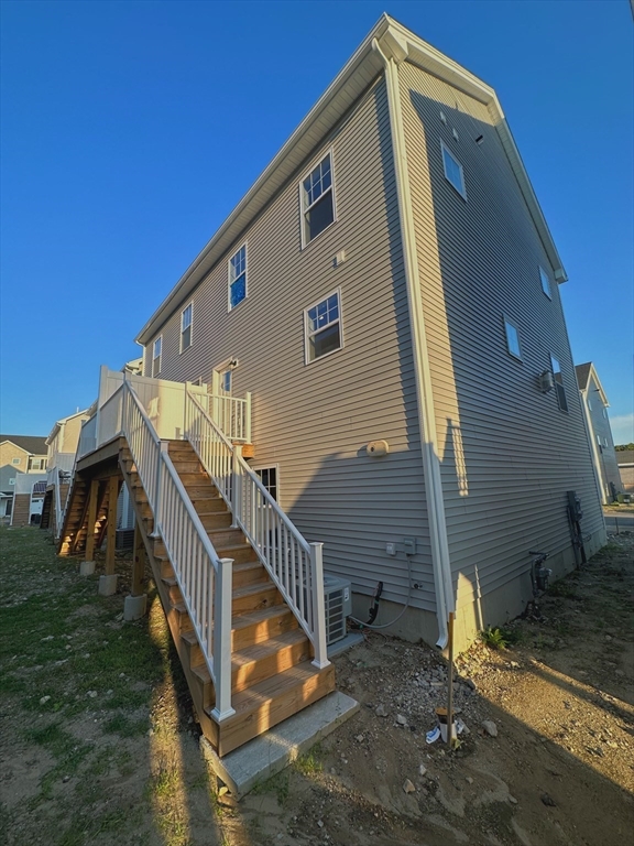 1400 Gorham Street, Unit 36 Lowell, MA 01852 - Photo 2 of 17 a front view of a house with stairs