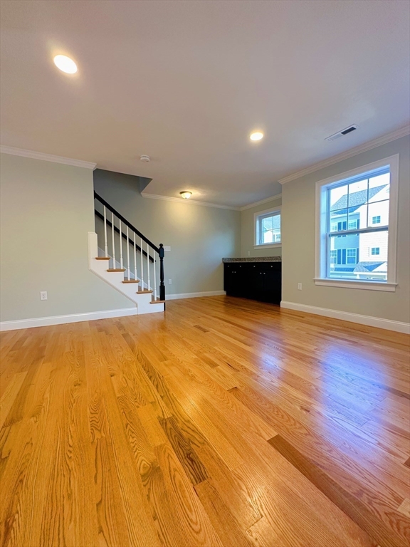 1400 Gorham Street, Unit 36 Lowell, MA 01852 - Photo 7 of 17 a view of an empty room with wooden floor and a window