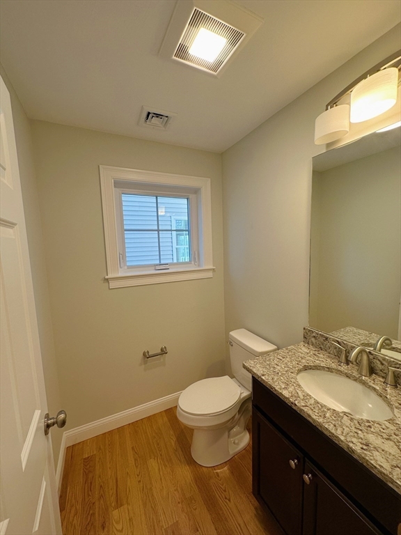 1400 Gorham Street, Unit 36 Lowell, MA 01852 - Photo 9 of 17 a bathroom with a granite countertop sink toilet and a mirror