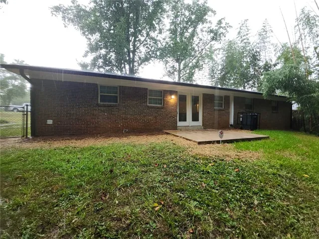 a backyard of a house with garden and porch