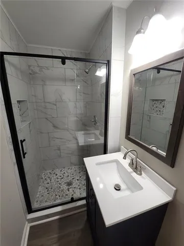 a bathroom with a sink a mirror and shower