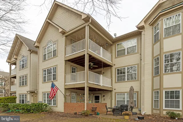 a front view of a residential apartment building with a yard