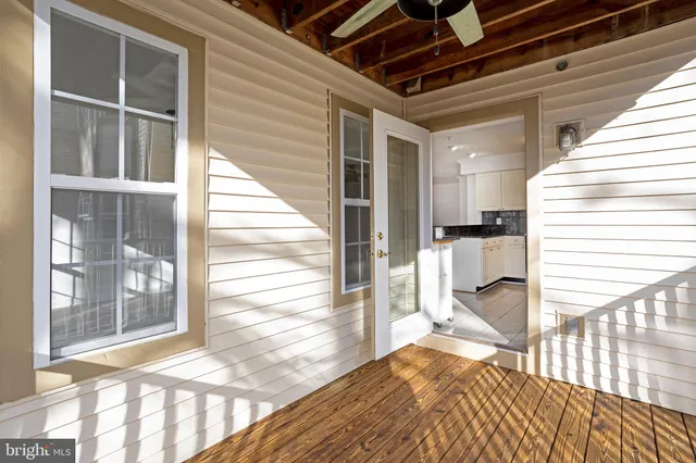 a view of a room with wooden floor and windows