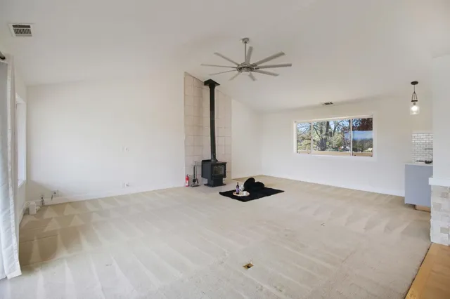 a kitchen with stainless steel appliances granite countertop a stove and a large window