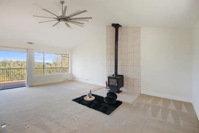 a kitchen with stove and a large window