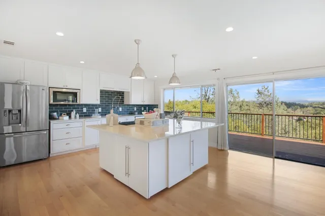 a view of balcony with wooden floor & fence