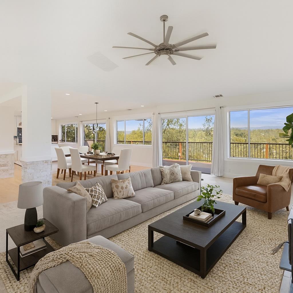 1276 Coon Court Cool, CA 95614 - Photo 2 of 79 a living room with furniture a large window and a chandelier