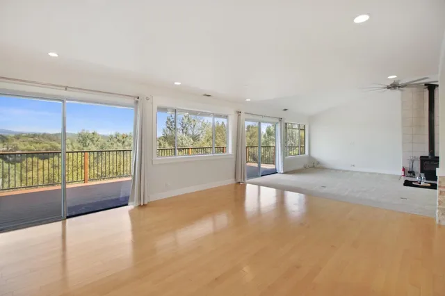 a large kitchen with stainless steel appliances a large counter top and a refrigerator