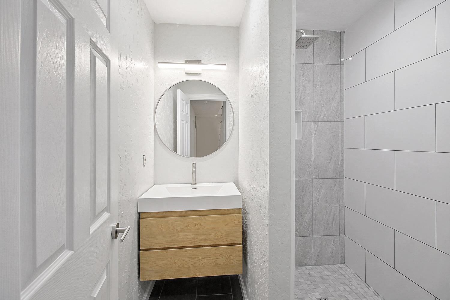 1276 Coon Court Cool, CA 95614 - Photo 33 of 79 a bathroom with a sink and a mirror