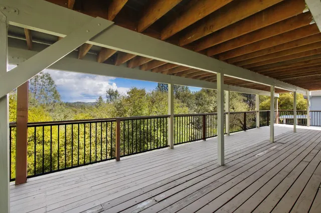 an aerial view of residential house with outdoor space and trees