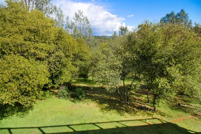 a view of a swimming pool with a yard and lake view