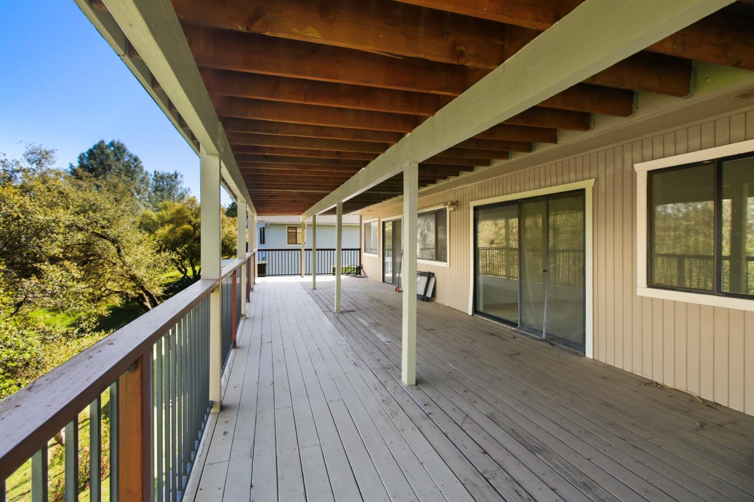 1276 Coon Court Cool, CA 95614 - Photo 48 of 79 a view of a balcony with wooden floor and fence