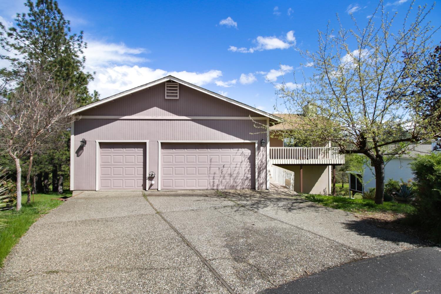 1276 Coon Court Cool, CA 95614 - Photo 51 of 79 a front view of a house with a yard and garage