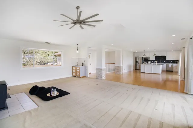 a view of a bedroom with a bed and a window