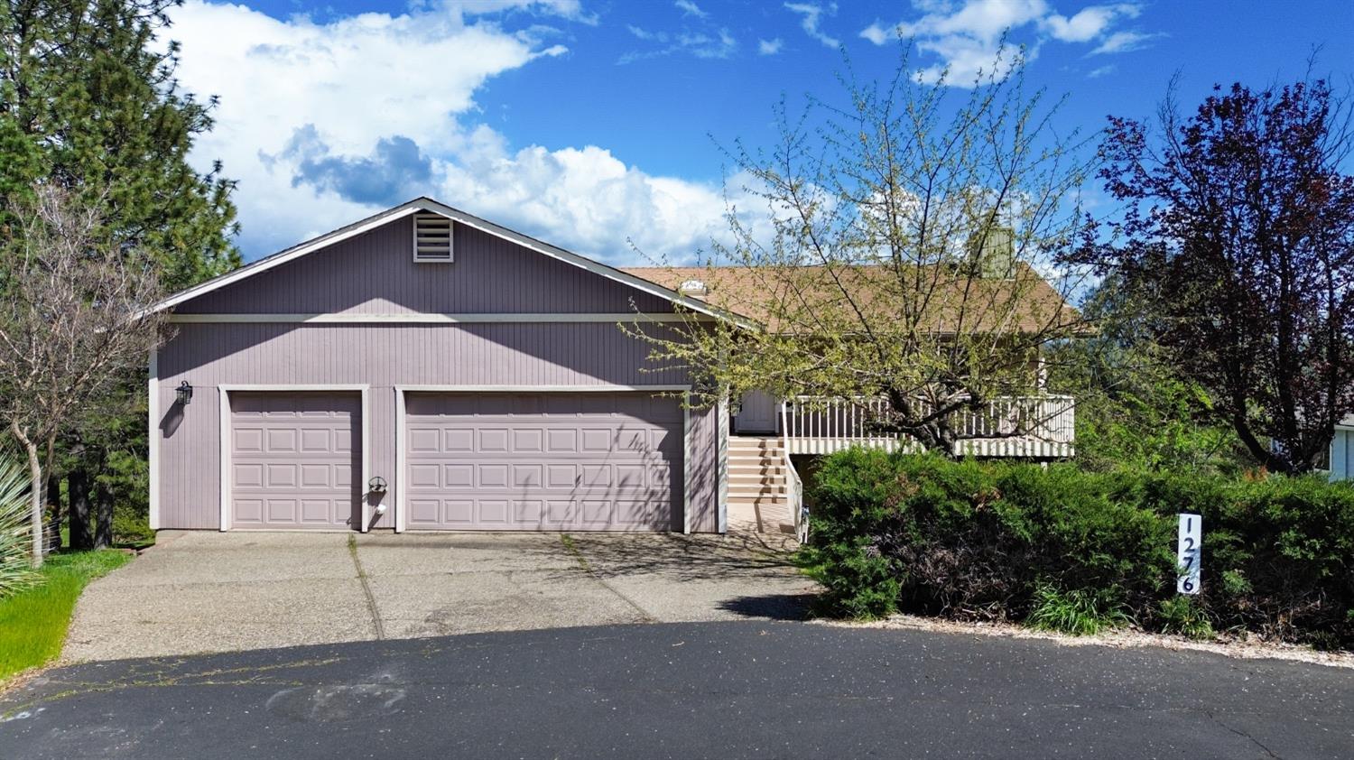 1276 Coon Court Cool, CA 95614 - Photo 69 of 79 a front view of a house with a yard and garage