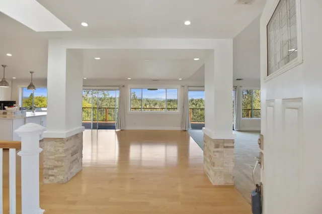 a view of kitchen with kitchen island and stainless steel appliances
